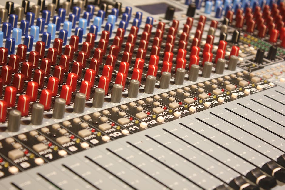 An image of a mixing board with various knobs and sliders, representing the art of mix engineering.