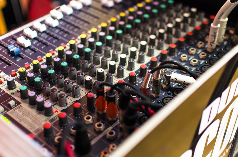 An image of a multitrack recording console with various knobs and buttons.