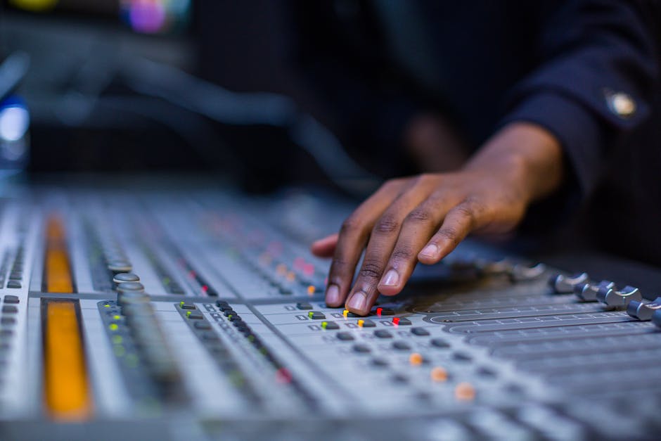 Illustration of a person sitting at a mixing console, adjusting the levels on different tracks.