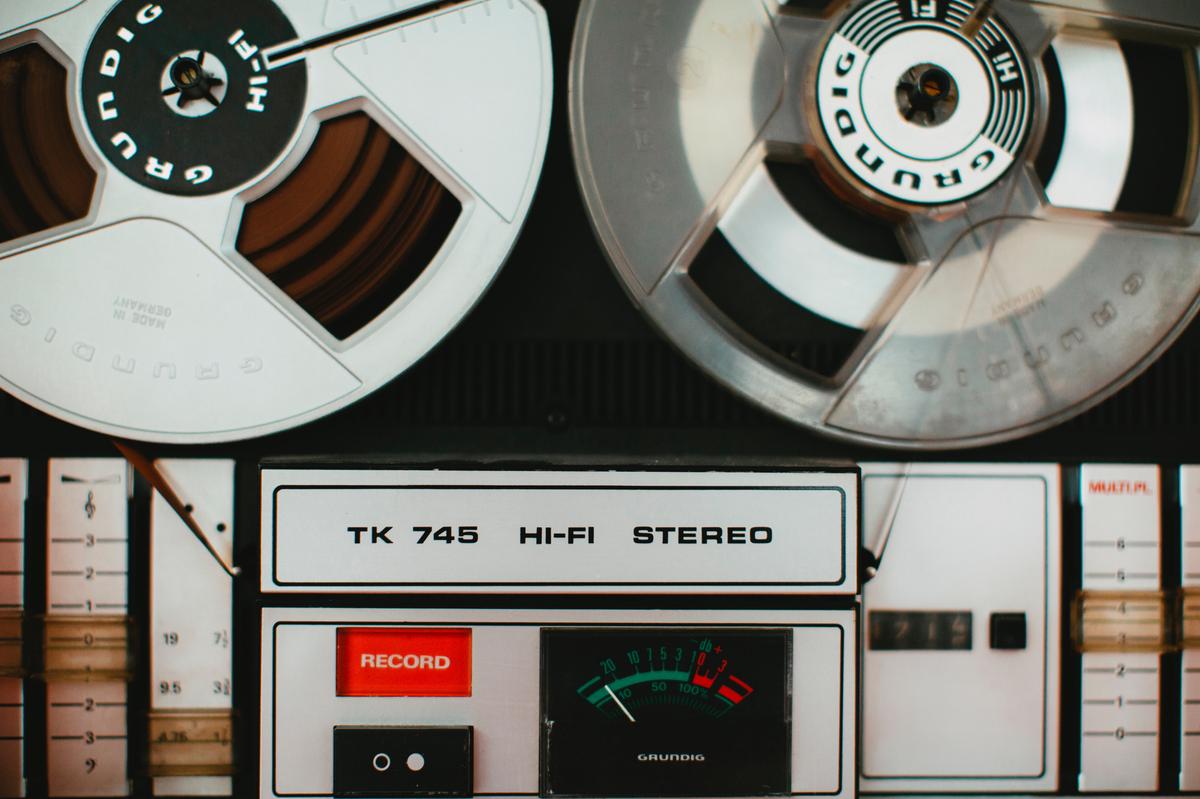 An image of a tape recorder with tape reels spinning.